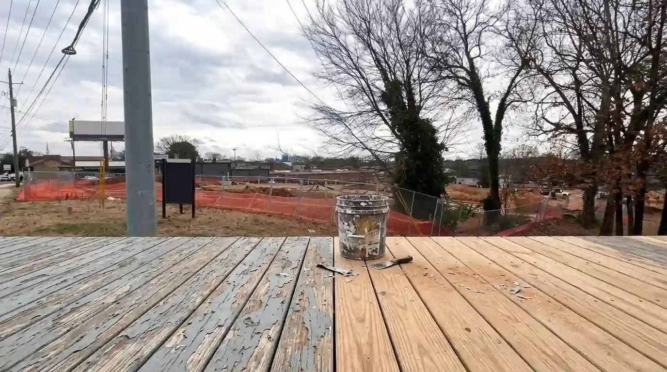 Deck boards half stripped of peeling paint