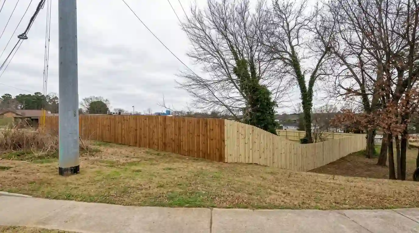 Pine privacy fence partly stained warm brown
