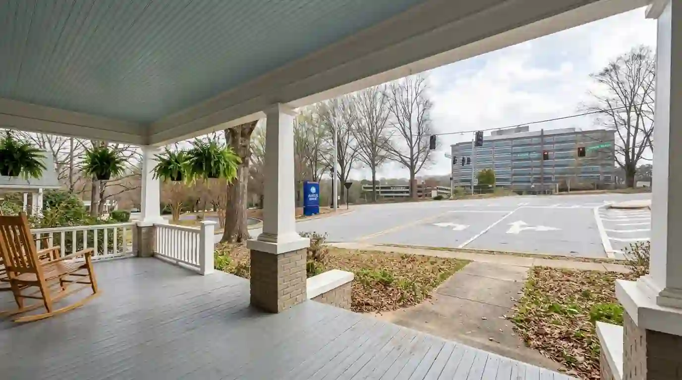 Gray porch floor under a pale blue beadboard ceiling