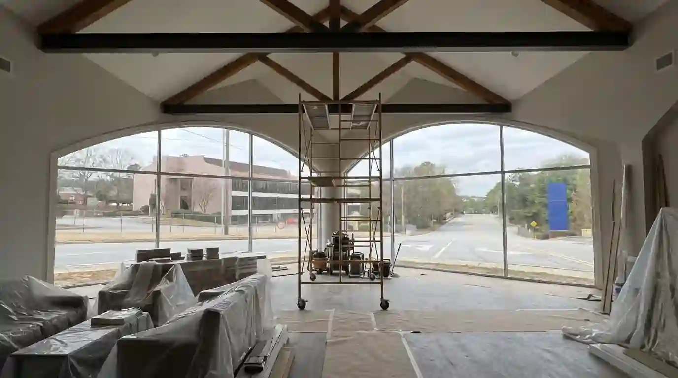 Rolling scaffold under a vaulted great room ceiling