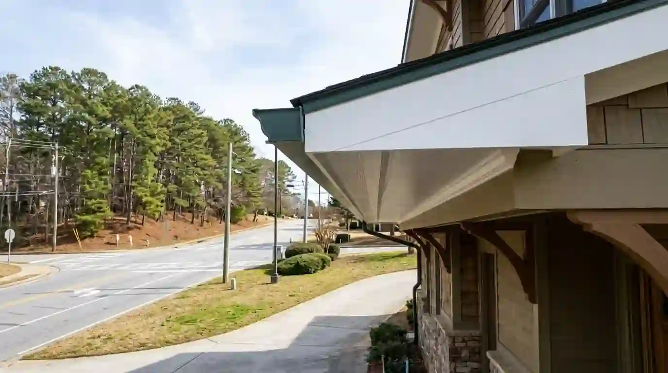 White fascia and vented soffit freshly painted under a gutter