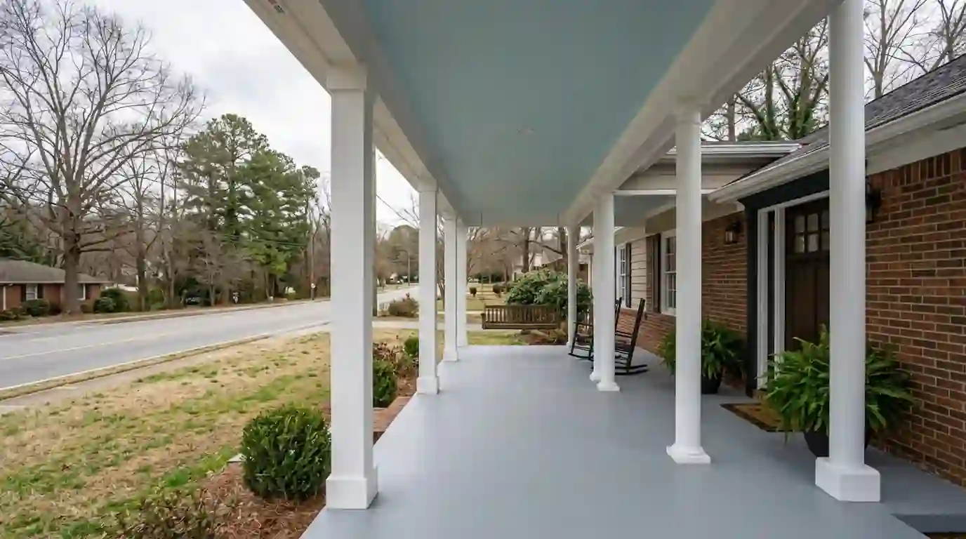 Painted front porch with white columns, gray floor and pale blue ceiling