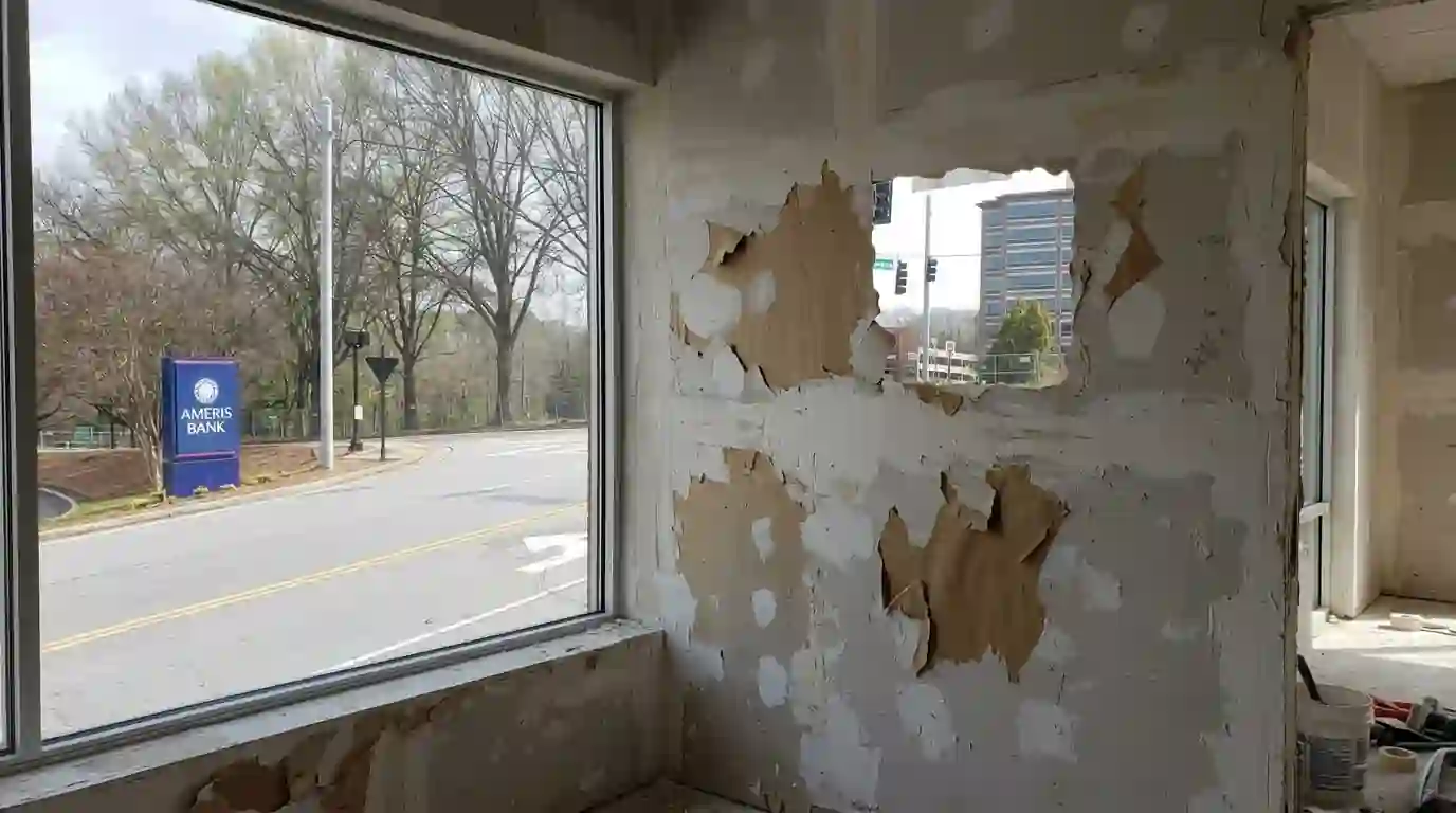 Torn drywall face paper sealed with primer after removal