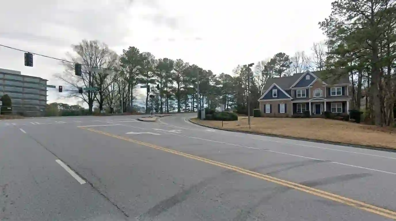 Two-story suburban home with fresh navy shutters in Alpharetta
