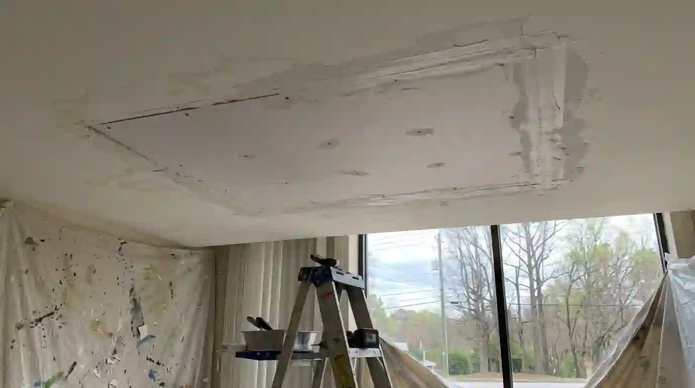 New drywall patch in a ceiling after a leak