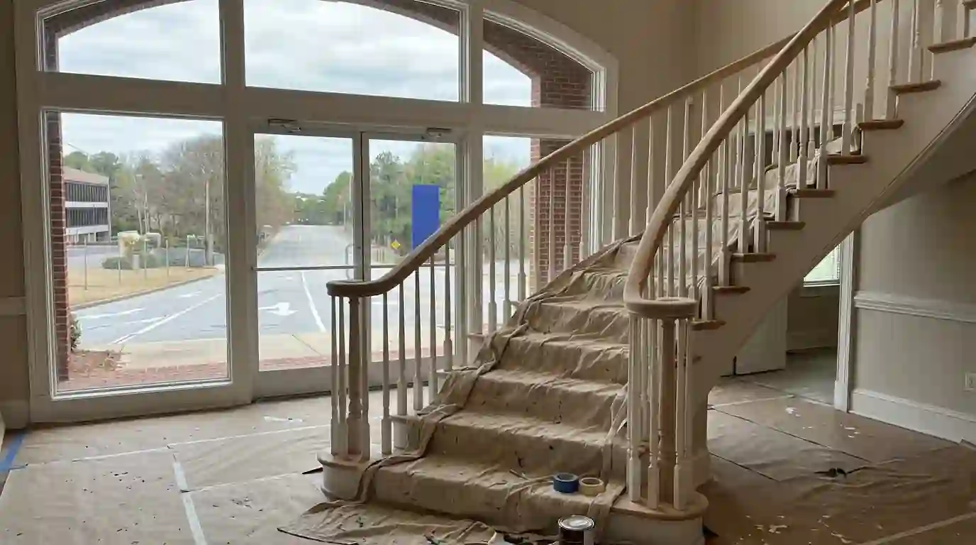 Sanded handrail and white balusters on a curved staircase